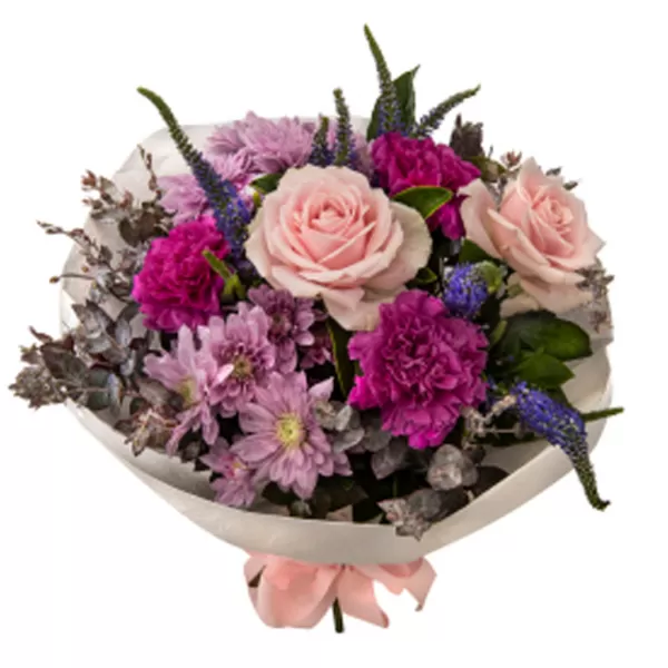 A detailed shot of a bouquet containing pink roses, dark pink and purple carnations, purple chrysanthemums, and blue veronica flowers, wrapped in white paper and tied with a pink ribbon at the base.