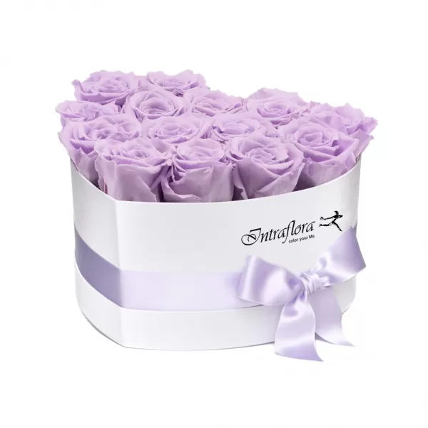 A white, heart-shaped box filled with light purple roses, wrapped with a light purple ribbon and bow, against a white background. The box also features the "Intraflora" logo.