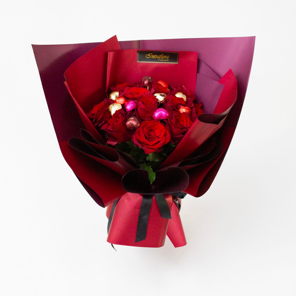 Elegant Valentine's bouquet with 12 premium red roses, wrapped in red and black ribbon, paired with mini heart-shaped chocolates."