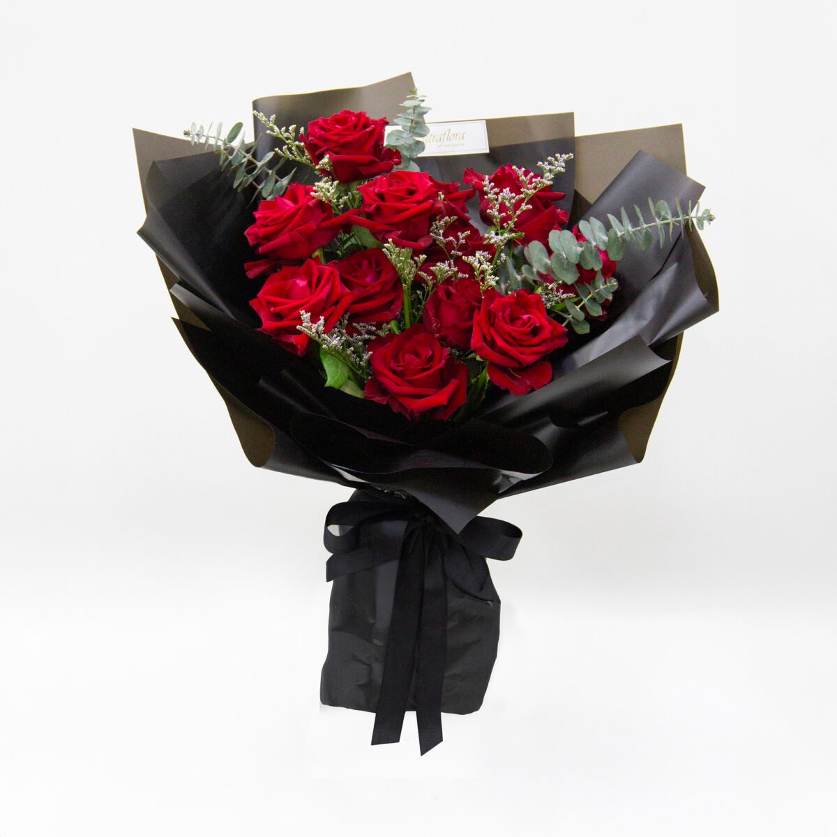 Elegant bouquet with 12 Ever Red roses, 5 purple limonium caspia, and 5 eucalyptus cinerea, wrapped in black with a matching black ribbon